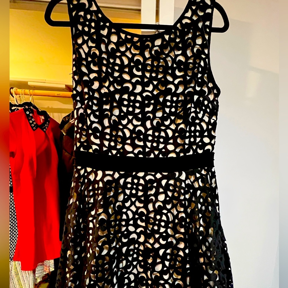 Beautiful Xscape dress size 12. Black decorative cutout overlay with nude slip.
